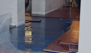 Water Damage Covered By Home Insurance - floor pulled up from water damage