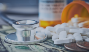 medical costs in retirement - pill bottle, money, and a stethoscope